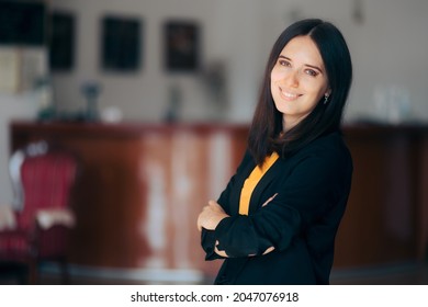 Hotel Receptionist Woman Welcoming Guests With A Smile. Businesswoman Standing With Arms Crossed Inside Office Building
