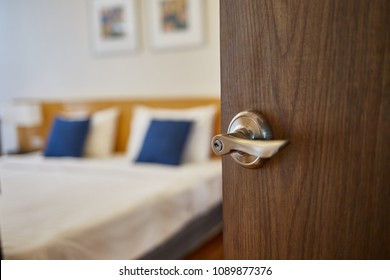 Hotel Room , Condominium Or Apartment Doorway With Open Door In Front Of Blur Bedroom Background