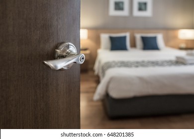 Hotel Room , Condominium Or Apartment Doorway With Open Door In Front Of Blur Bedroom Background