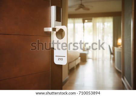 The hotel room with Room Number sign on the door
