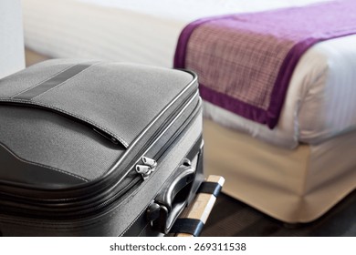 Hotel Room With A Suitcase On The Luggage Place And The Bed