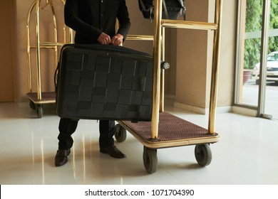 Hotel Servant Putting Luggage On Cart