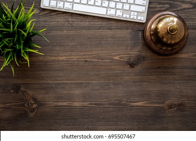 Hotel Service Bell On Dark Wooden Table Top View Copyspace