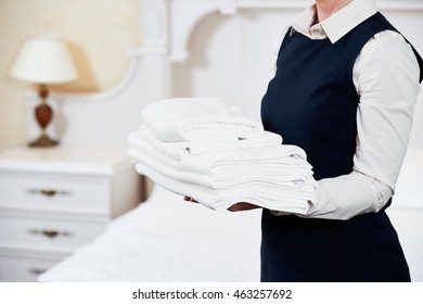 Hotel services. housekeeping maid with linen - Shutterstock ID 463257692
