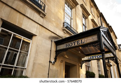 Hotel Sign Over The Entrance To An Old Stone Building