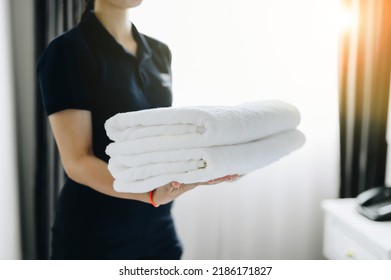 hotel staff cleaning ; Organize items in the bedroom ; pillow ; blanket . hotel room - Shutterstock ID 2186171827