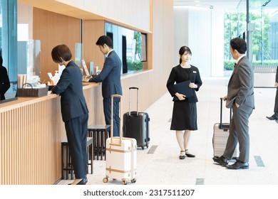 Hotel staff showing guests around - Powered by Shutterstock