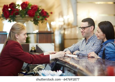 Hotel Staff Talking To Just Arrived Couple Of Travelers