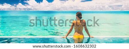 Hotel swimming pool luxury travel vacation summer holiday panoramic banner background with woman in bikini enjoyin sun tan swim lifestyle.