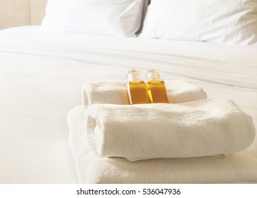 Hotel Towel With Shampoo And Soap Bottle Set On White Bed