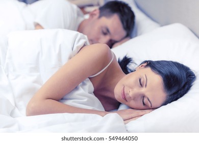 Hotel, Travel, Relationships, And Happiness Concept - Happy Couple Sleeping In Bed