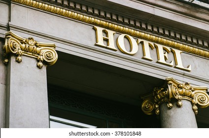 Hotel word with golden letters on luxury hotel with beautiful columns