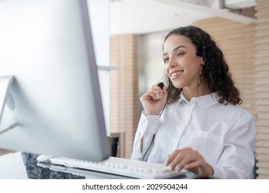 Hotline. happy young caucasian female call center customer support executive with headset working in office, education online, customer support service, call center, phone operator, video call concept