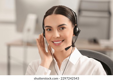 Hotline operator with headset working in office