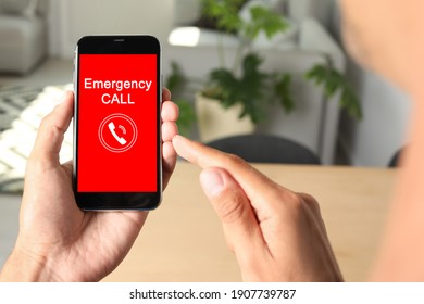 Hotline Service. Man Making Emergency Call Via Smartphone Indoors, Closeup