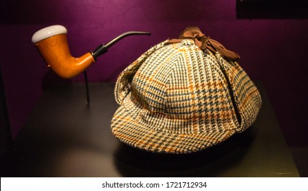 A Houndstooth Deer Stalker Hat And A Briar Pipe Made Famous By Fictional Detective, Sherlock Holmes