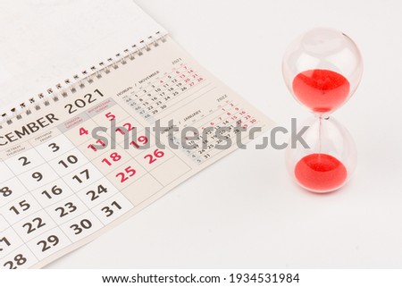 Hour glass and calendar concept for time slipping away for important appointment date, schedule and deadline