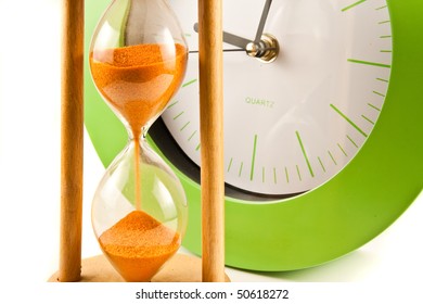 Hour Glass And Green Clock On White