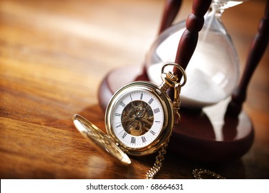 Hour glass or sand timer with vintage pocket watch, symbols of time with copy space - Powered by Shutterstock