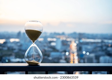 Hourglass in focus with buildings in background, Hourglass with cityscape on panoramic skyline and buildings in the morning background, The concept of modern life, time, management and city life. - Powered by Shutterstock - Get 15% off with code: PIKWIZARD15
