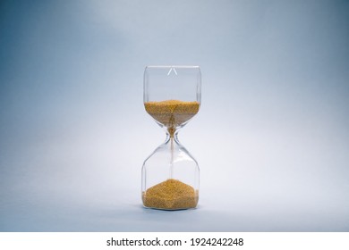 hourglass with golden sand pouring inside, eternal time, infinity, business time