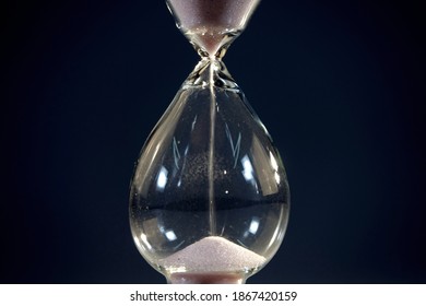 Hourglass. Sands Move Through Hour Glass. Close Up.