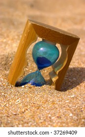 Hourglass Sinking Into Sand