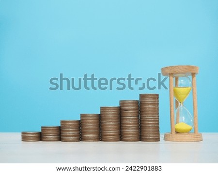 Hourglass and stack of coins. The concept of saving money, manage time to business achievement goal, Financial, Investment and Business growing