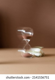 Hourglass time passing dark background. Art photography of hourglass with blurred contour. Art photography. Long exposure photo