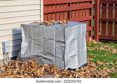 House air conditioning unit with protective cover during fall season. Concept of home air conditioning, hvac, repair, service, winterize and maintenance. - Shutterstock ID 2225255751