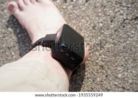 House arrest GPS jail monitoring bracelet on male ankle due to jail sentence.  