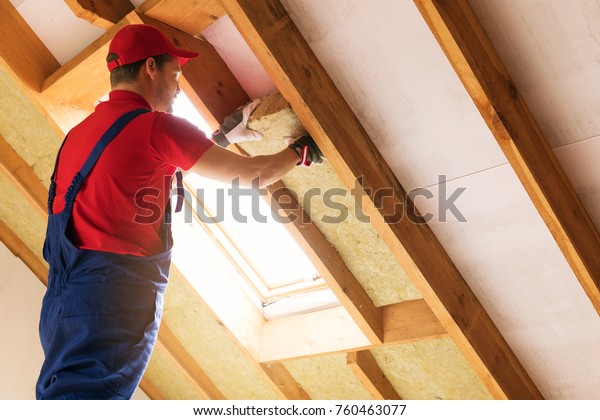 house attic insulation - construction worker\
installing rock wool in mansard\
wall