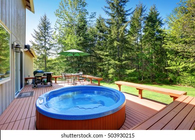 House Backyard With Hot Tub, Barbecue And Patio Table Set. Northwest, USa