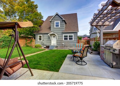 House Backyard With Small Patio Area And Garden Swing