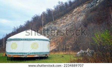 house Bashkir Turkic yurt on the background of a mountain with a forest