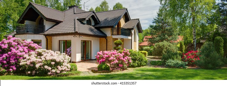 House With Beautiful Garden Full Of Flowers 