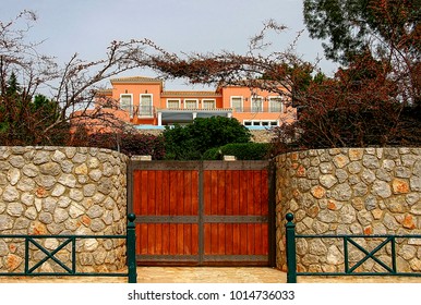 House with a beautiful wooden gate surrounded by stone walls