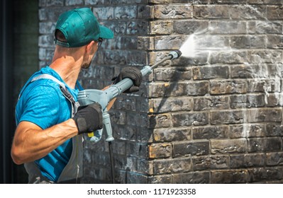 House Brick Wall Washing Using Pressure Washer. Caucasian Worker in His 30s. - Shutterstock ID 1171923358