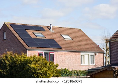 House With A Brown Roof With Solar Panels For Electric Power Generation