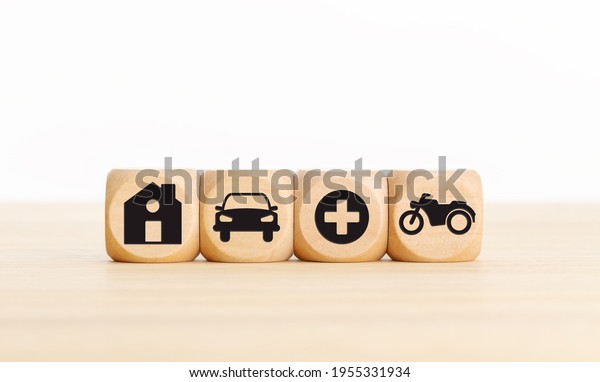 House, car, health and bike icons on\
wooden blocks Types of insurance concept. Copy\
space