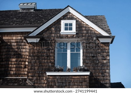 House with cedar shingles feels inviting. Your classic house facade with a bright window looks clean. Their traditional house with a flowerbox adds charm.
