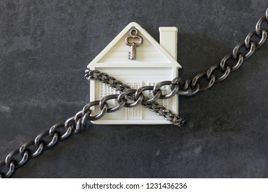  House in chains. Concept  -  risks, lose property,  seize, mortgage. 