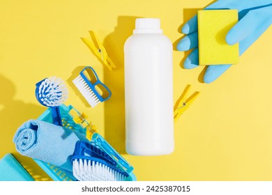 House cleaning product on yellow background with a white bottle mockup for detergents product. The cleaning tool with blue color stand out. Space for design - Powered by Shutterstock