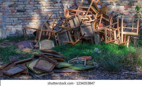 House Clearance In Front Of A Bricked Wall With A Lot Of Chairs