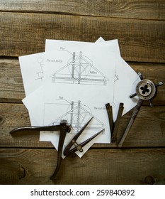 House construction. Many drawings for building and old working tools on old wooden background.