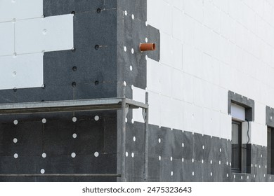 house construction process involves insulating the walls with modern thermal insulation materials. Exterior covering is applied at the construction site.