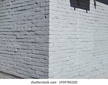 House Corner, Brick Wall Painted With White Paint.