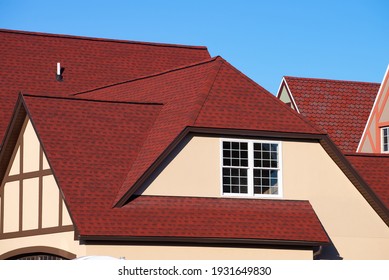 the house is covered with a red shingle material roof