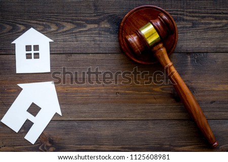 House cutout near judge gavel on dark wooden background top view copy space. Housing law. Property division. Real estate auction