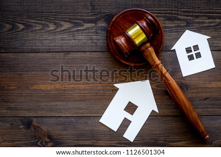 House cutout near judge gavel on dark wooden background top view copy space. Housing law. Property division. Real estate auction